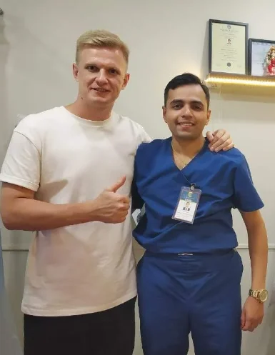 Happy cosmetic dentistry smile restoration patient with Dr. S. Bhargava at CTOMATODONT